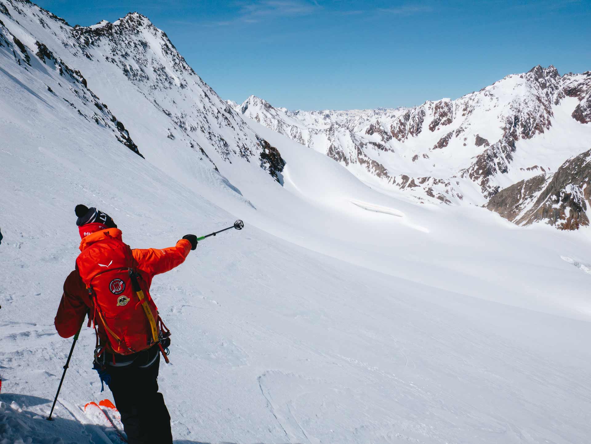 guide-zeigt-mit-skistock-am-gletscher